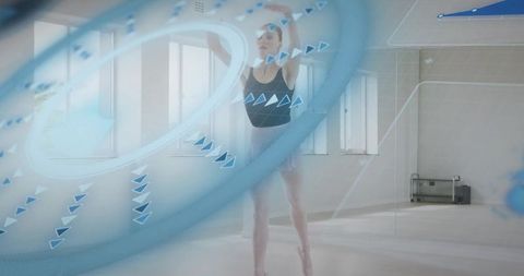 Ballerina performing en pointe with blue augmented reality motion graphics in airy studio