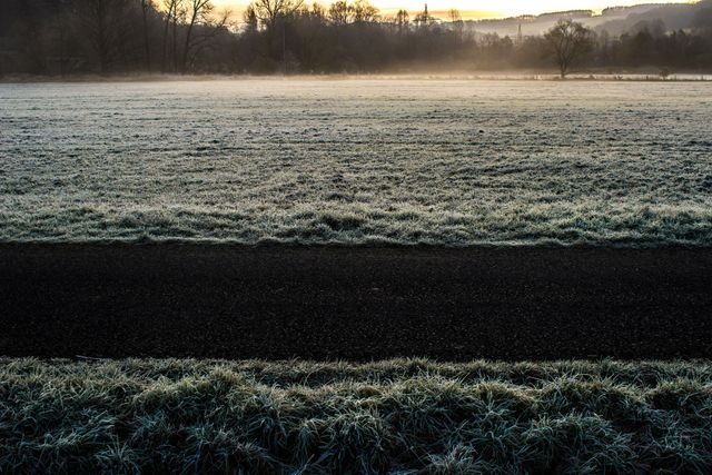 Frosty Field at Dawn with Misty Horizon and Rising Sun - Download Free Stock Photos Pikwizard.com