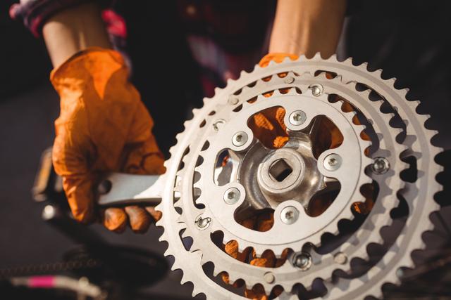 This image is ideal for use in articles or advertisements related to bicycle repair, maintenance, and cycling gear. It can be used by bike shops, repair services, or cycling blogs to illustrate the intricacies of bike maintenance and the expertise of mechanics.