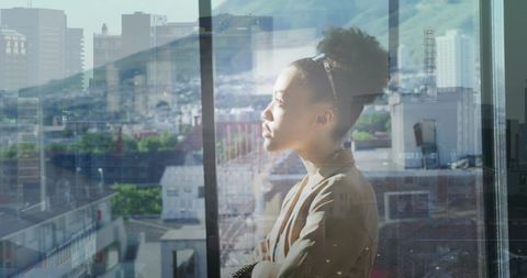 African American Businesswoman Overlooking Cityscape with Futuristic Overlay