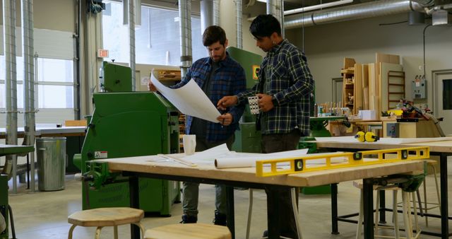 Two Colleagues Discussing Project in Workshop Setting - Download Free Stock Images Pikwizard.com