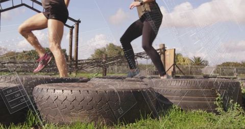 Women Training in Outdoor Agility Course with Tires