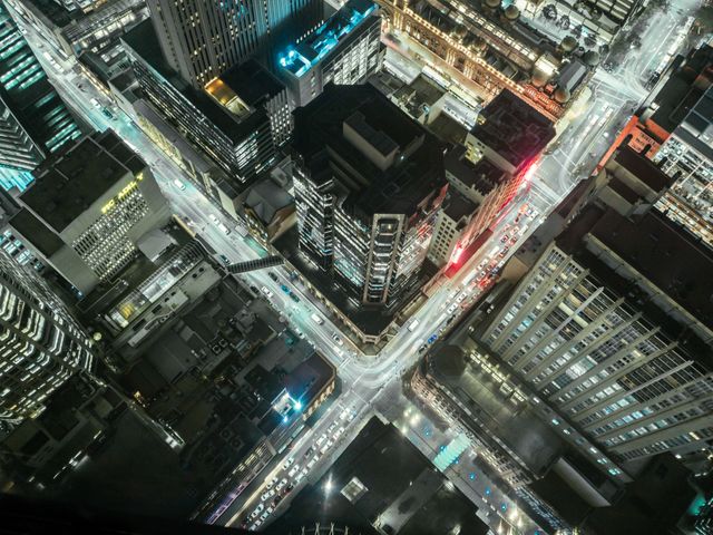 Aerial View of City Intersection at Night with Downtown Lit Up - Download Free Stock Photos Pikwizard.com