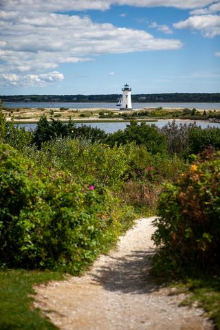 Scenic Coastal Pathway Leading to Majestic Lighthouse