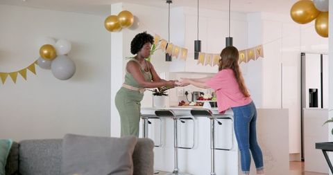 Couple preparing home birthday celebration with decor