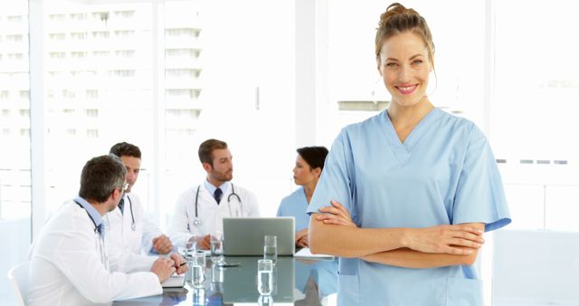 Confident Nurse in Hospital Meeting Room with Team of Doctors - Download Free Stock Images Pikwizard.com