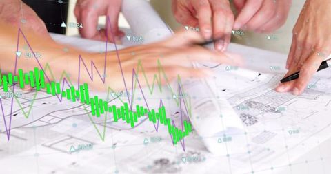 Collaborating architects and analysts reviewing blueprints with financial data overlay