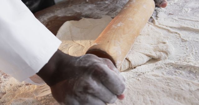 Baker Rolling Dough with Wooden Rolling Pin on Floured Surface - Download Free Stock Images Pikwizard.com