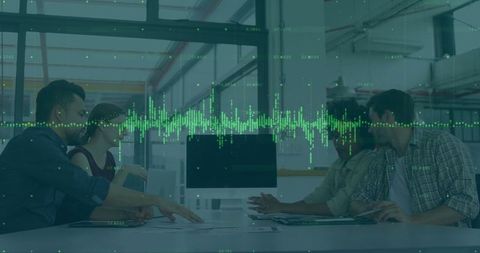 Team Analyzing Data in Modern Office Conference Room Using Technology