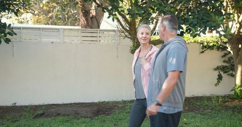 Senior Couple Enjoying Walk Together in Peaceful Backyard