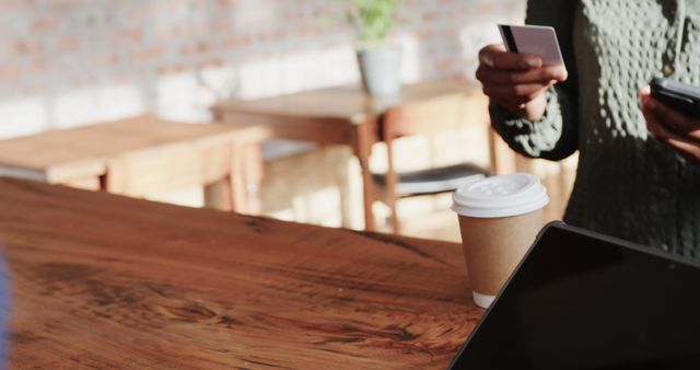 Person Using Smartphone and Holding Credit Card in Cafeteria - Download Free Stock Images Pikwizard.com