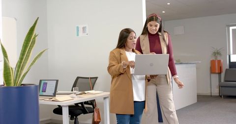 Diverse Businesswomen Collaborate in Modern Office Space