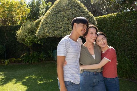 Happy Family Bonding in Serene Backyard Garden Setting