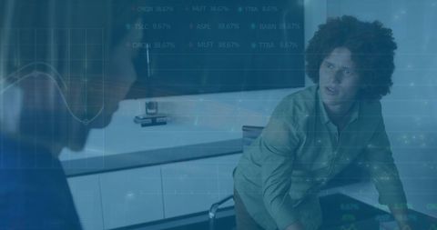 Colleagues Engaging with Financial Data in Modern Office Environment