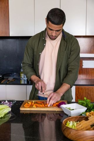 Man Preparing Fresh Veggies in Modern Kitchen Setting