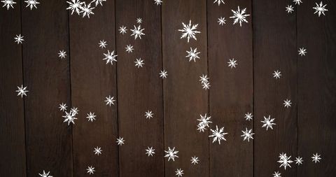 Falling Snowflakes on Rustic Wooden Background for Festive Designs