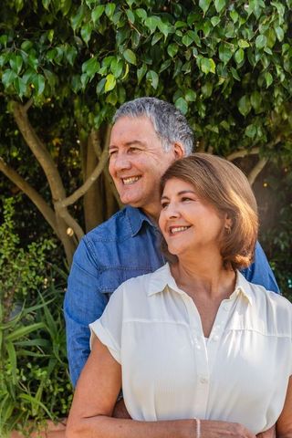 Happy Senior Couple Embracing in Lush Garden Setting