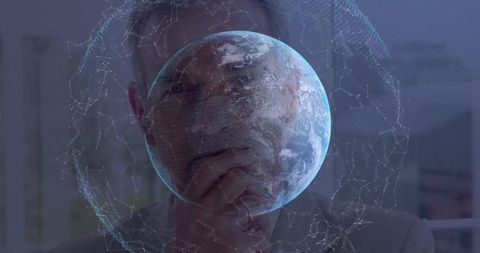 Executive contemplating holographic earth mesh network representing global strategy