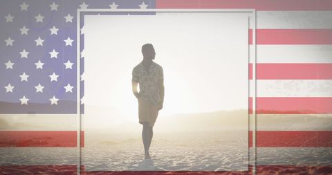 Silhouette of Man on Beach with American Flag Overlay
