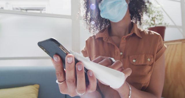 Woman Wearing Face Mask Sanitizing Smartphone Inside Modern Office - Download Free Stock Images Pikwizard.com