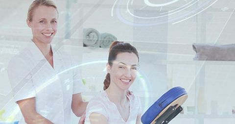 Therapist giving shoulder massage to client with digital wellness hud overlay