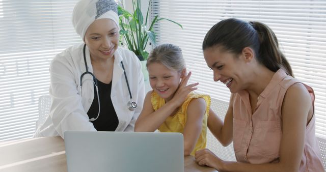 Doctor Interacting with Happy Family During Consultation - Download Free Stock Images Pikwizard.com