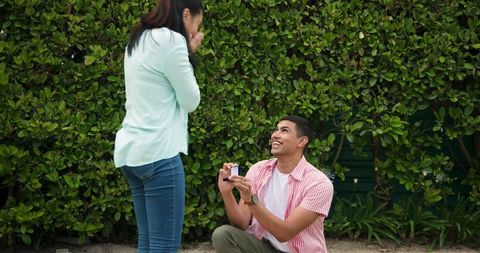 Man proposing in garden surprise engagement