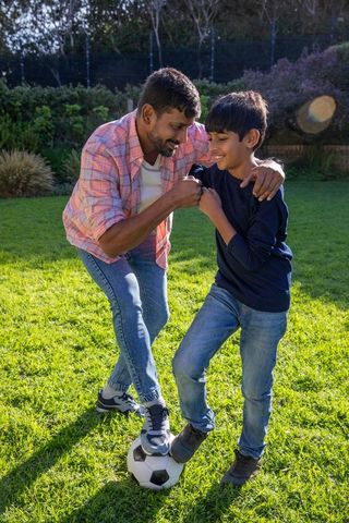 Father and Son Bonding During Outdoor Soccer Fun