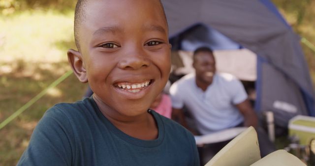 Smiling African American Boy Camping Outdoors with Family - Download Free Stock Images Pikwizard.com