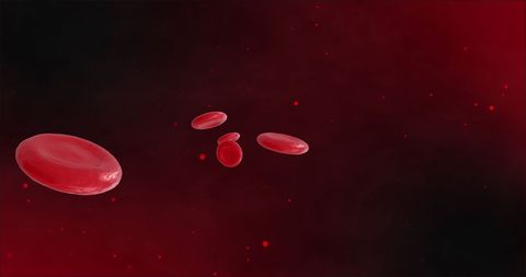 Red blood cells floating against a dark background