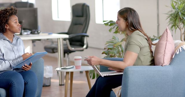 Businesswomen Talking in Modern Office with Notebooks - Download Free Stock Images Pikwizard.com