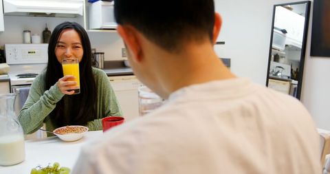 Happy Couple Enjoying Breakfast Together at Home in Kitchen