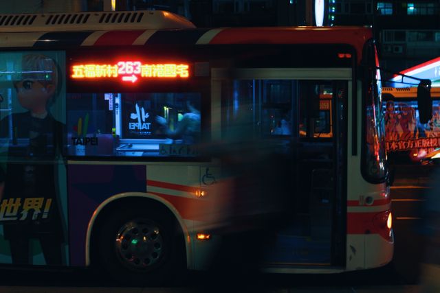 Photo depicts a public bus in Taipei at night with neon signs and vivid lights, ideal for representing night commuting in urban settings. Suitable for use in content about city life, Asia travel, transportation systems, or public transit promotions.