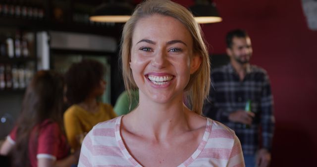 Smiling Blonde Woman Socializing in Casual Pub Setting - Download Free Stock Images Pikwizard.com