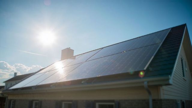 Solar panels on suburban roof capturing sunlight for sustainable energy