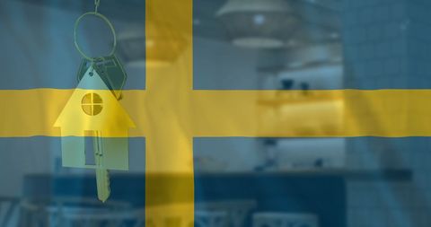 House key with swedish flag and office background symbolizing property ownership