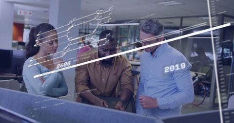 Colleagues Analyzing Interactive Financial Data in Modern Office