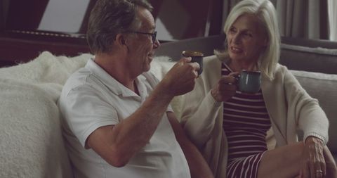 Senior couple savoring coffee in warm home environment