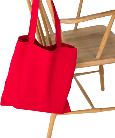 Red Shopping Tote Bag Hanging on Wooden Chair on Transparent Background