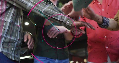 Adults joining forearms in teamwork huddle with magenta hud overlay, casual office unity