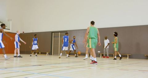 Diverse Basketball Teams Playing Intense Game on Indoor Court