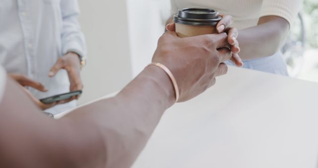 Close-Up of Two People Exchanging Coffee in Cafe - Download Free Stock Images Pikwizard.com