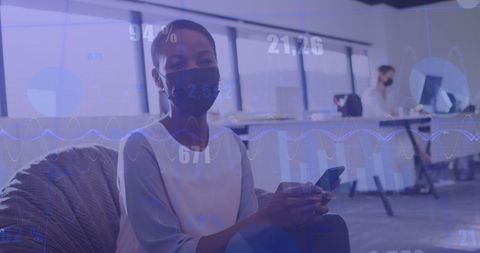 Businesswomen Analyzing Data with Pandemic Measures in Office