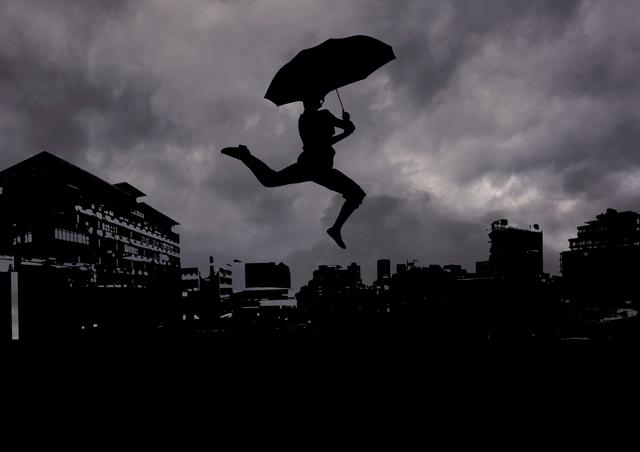 Silhouette of man jumping with umbrella against dramatic cityscape. Ideal for concepts of freedom, adventure, and urban life. Suitable for use in advertisements, posters, and creative projects emphasizing dynamic action and dramatic weather.