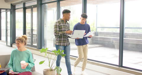 Diverse Colleagues Collaborating with Digital Tools in Modern Office