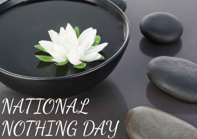 Close-up of white water-lily in bowl with pebbles on table and national nothing day text. text, communication, fresh and nothing day concept.