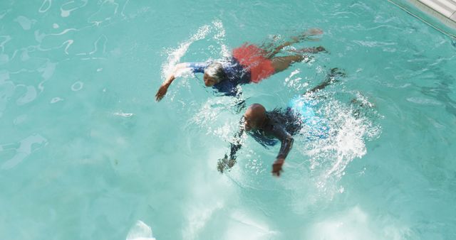 Image of happy senior african american couple swimming. Retirement lifestyle, spending time together,active leisure time.