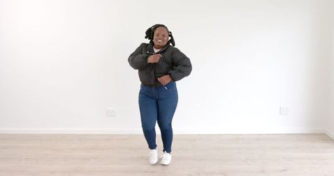 Joyful Woman Dancing Energetically Indoors in Casual Wear