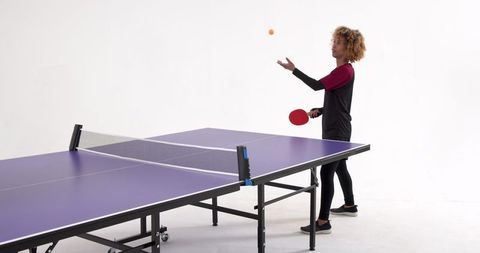 Energetic Female Table Tennis Player in Studio Minimalist Setting