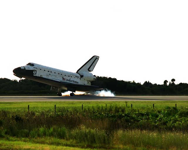 KENNEDY SPACE CENTER, Fla. -- The orbiter drag chute deploys after the Space Shuttle orbiter Atlantis lands on Runway 15 of the KSC Shuttle Landing Facility (SLF) at the conclusion of the nearly 11-day STS-86 mission. Main gear touchdown was at 5:55:09 p.m. EDT, Oct. 6, 1997, with an unofficial mission-elapsed time of 10 days, 19 hours, 20 minutes and 50 seconds. The first two KSC landing opportunities on Sunday were waved off because of weather concerns. The 87th Space Shuttle mission was the 40th landing of the Shuttle at KSC. On Sunday evening, the Space Shuttle program reached a milestone: The total flight time of the Shuttle passed the two-year mark. STS86 was the seventh of nine planned dockings of the Space Shuttle with the Russian Space Station Mir. STS-86 Mission Specialist David A. Wolf replaced NASA astronaut and Mir 24 crew member C. Michael Foale, who has been on the Mir since mid-May. Foale returned to Earth on Atlantis with the remainder of the STS-86 crew. The other crew members are Commander James D. Wetherbee, Pilot Michael J. Bloomfield, and Mission Specialists Wendy B. Lawrence, Scott E. Parazynski, Vladimir Georgievich Titov of the Russian Space Agency, and Jean-Loup J.M. Chretien of the French Space Agency, CNES. Wolf is scheduled to remain on the Mir until the STS-89 Shuttle mission in January. Besides the docking and crew exchange, STS-86 included the transfer of more than three-and-a-half tons of science/logistical equipment and supplies between the two orbiting spacecraft. Parazynski and Titov also conducted a spacewalk while Atlantis and the Mir were docked